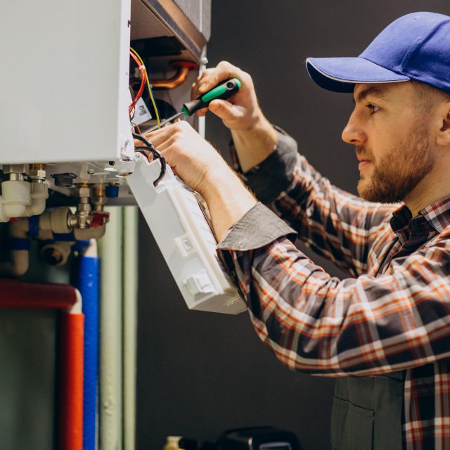 Service man adjusting house heating system